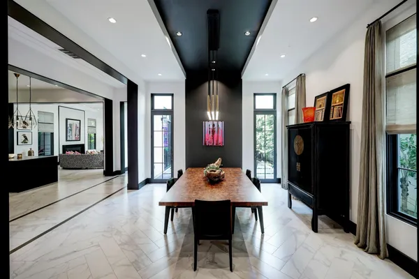 a dining room with wooden floor and a table