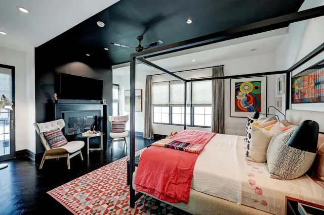 a bedroom with a bed dresser and painting on the wall