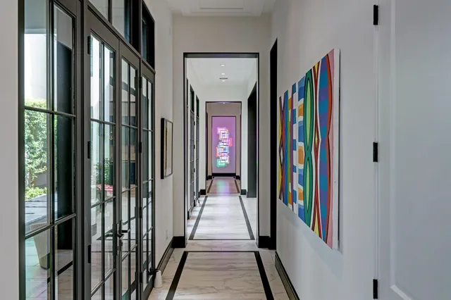 a view of a hallway with wooden floor and stairs