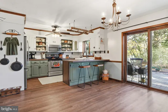 a kitchen with stainless steel appliances granite countertop a sink and cabinets