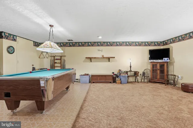 a room with pool table and flat screen tv