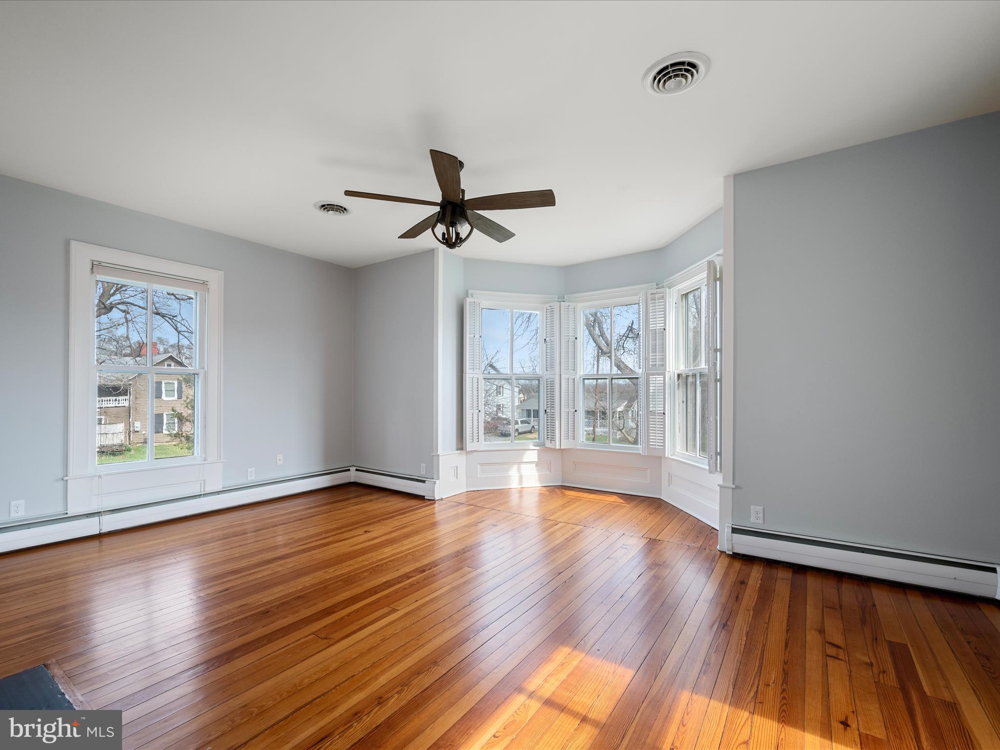 7919 Church Street Middletown, VA 22645 - Photo 20 of 48 a view of livingroom with hardwood floor and a ceiling fan