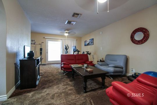 900 North Sierra View Street Ridgecrest, CA 93555 - Photo 6 of 42 a living room with furniture and a wooden floor