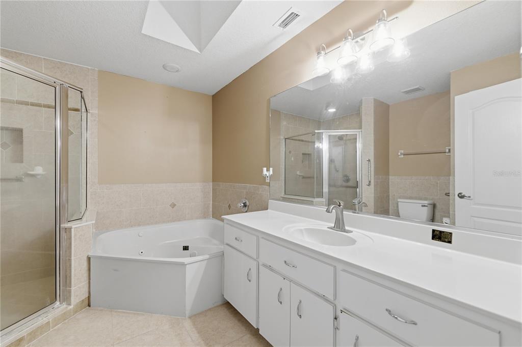 5365 Southwest 84th Place Ocala, FL 34476 - Photo 17 of 28 a bathroom with a tub shower sink and mirror
