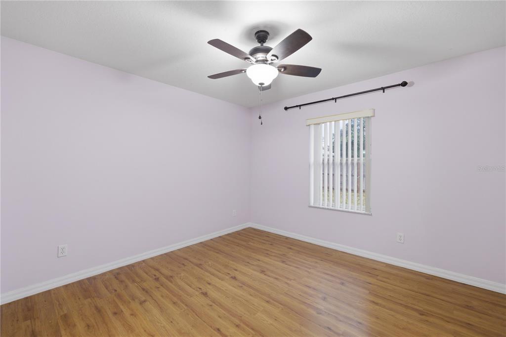 5365 Southwest 84th Place Ocala, FL 34476 - Photo 21 of 28 a view of an empty room with wooden floor and a window