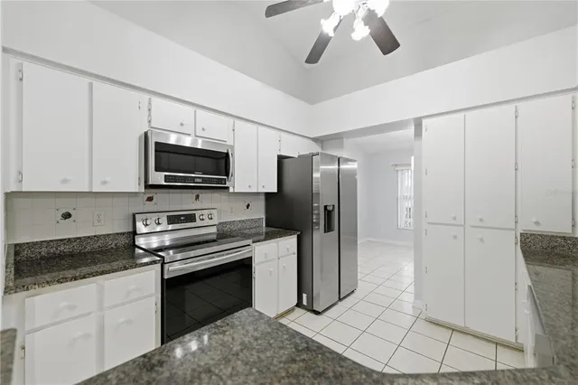 a kitchen with stainless steel appliances a refrigerator sink and microwave