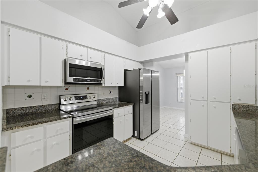 5365 Southwest 84th Place Ocala, FL 34476 - Photo 9 of 28 a kitchen with stainless steel appliances a refrigerator sink and microwave