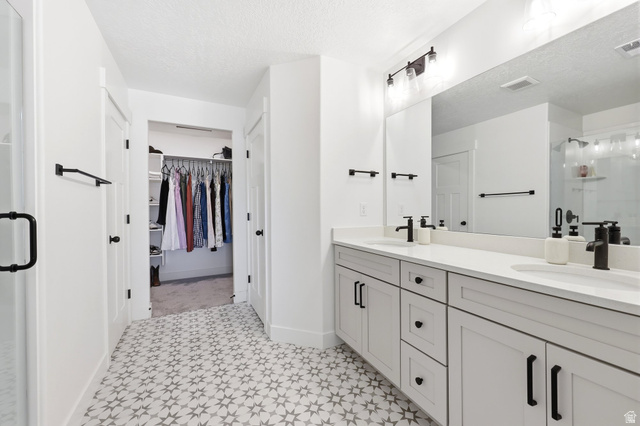 4646 Alder Drive, Unit 223 Mapleton, UT 84664 - Photo 13 of 35 Spacious bathroom featuring a dual vanity with white countertops, light gray cabinetry, and matte black fixtures