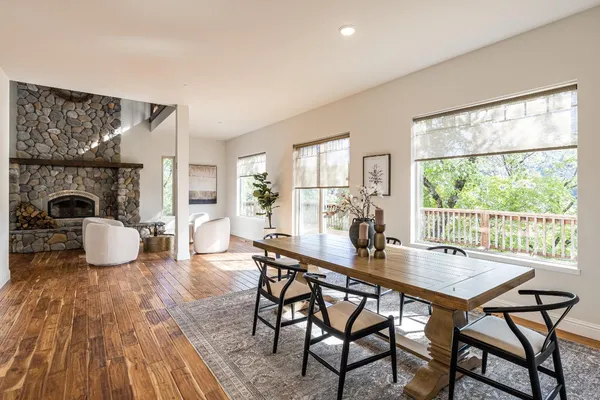 a view of a livingroom with wooden floor and a bathroom