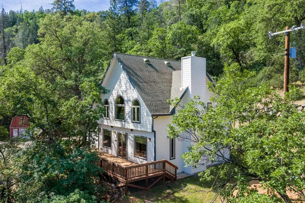 an aerial view of a house with yard table and chairs
