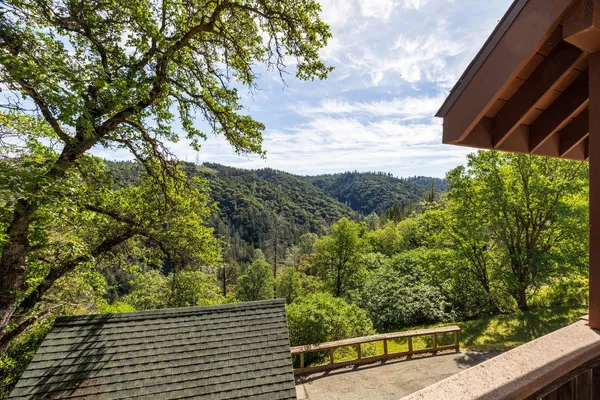 a view of an empty room with closet and a window
