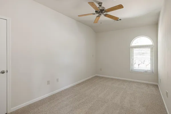 a kitchen with stainless steel appliances granite countertop a table chairs stove and refrigerator
