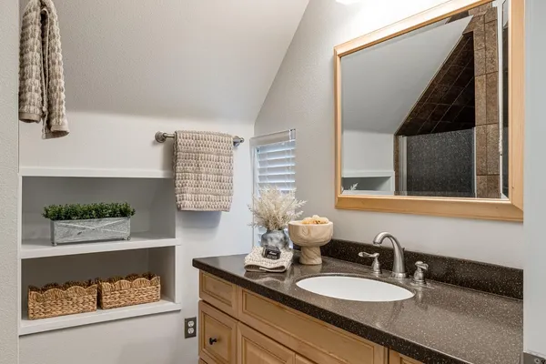 a kitchen with stainless steel appliances granite countertop a stove a sink dishwasher and cabinets with wooden floor