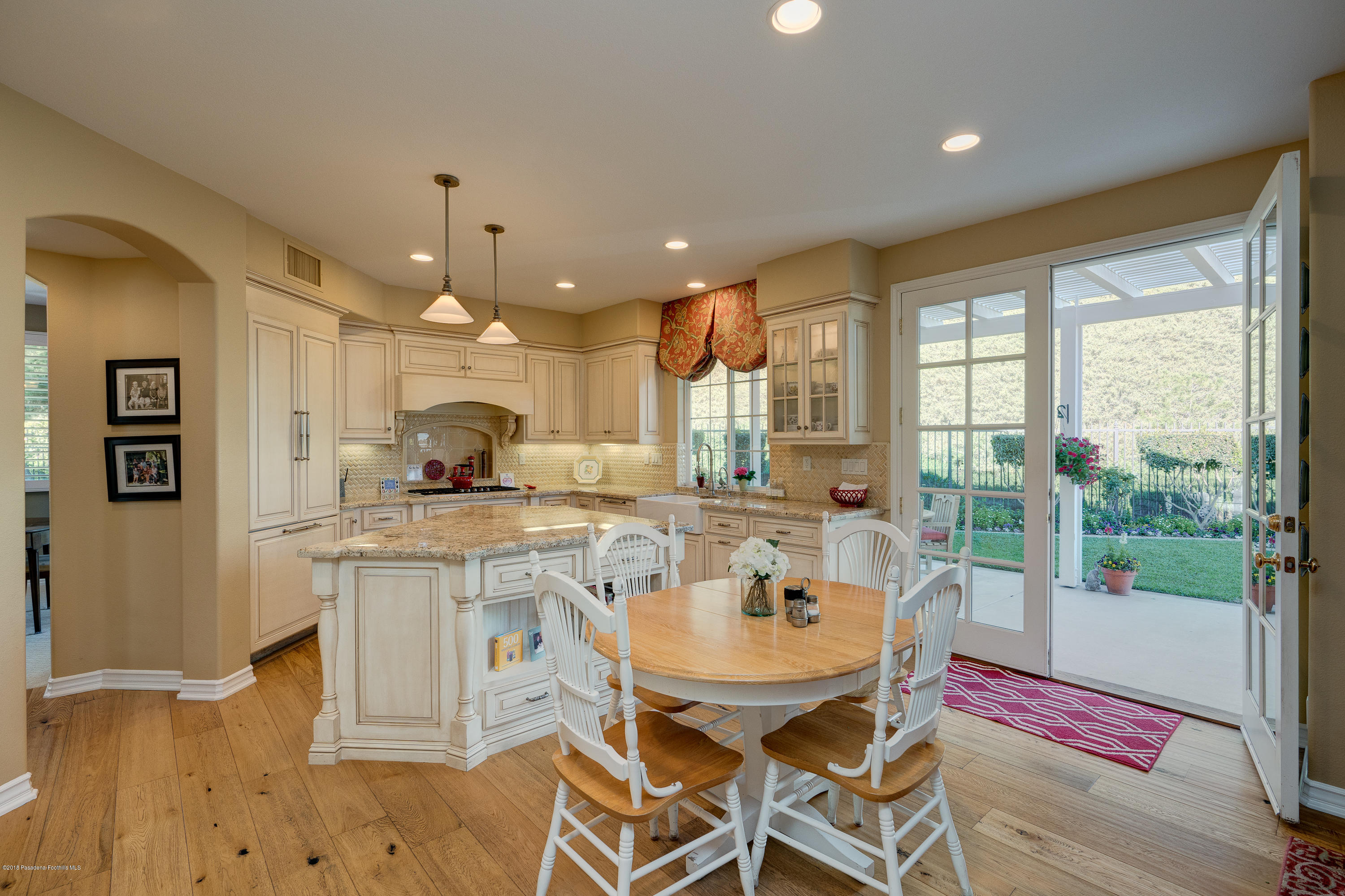 3520 Giddings Ranch Road Altadena, CA 91001 - Photo 9 of 41 a dining hall with stainless steel appliances granite countertop a dining table and chairs with wooden floor