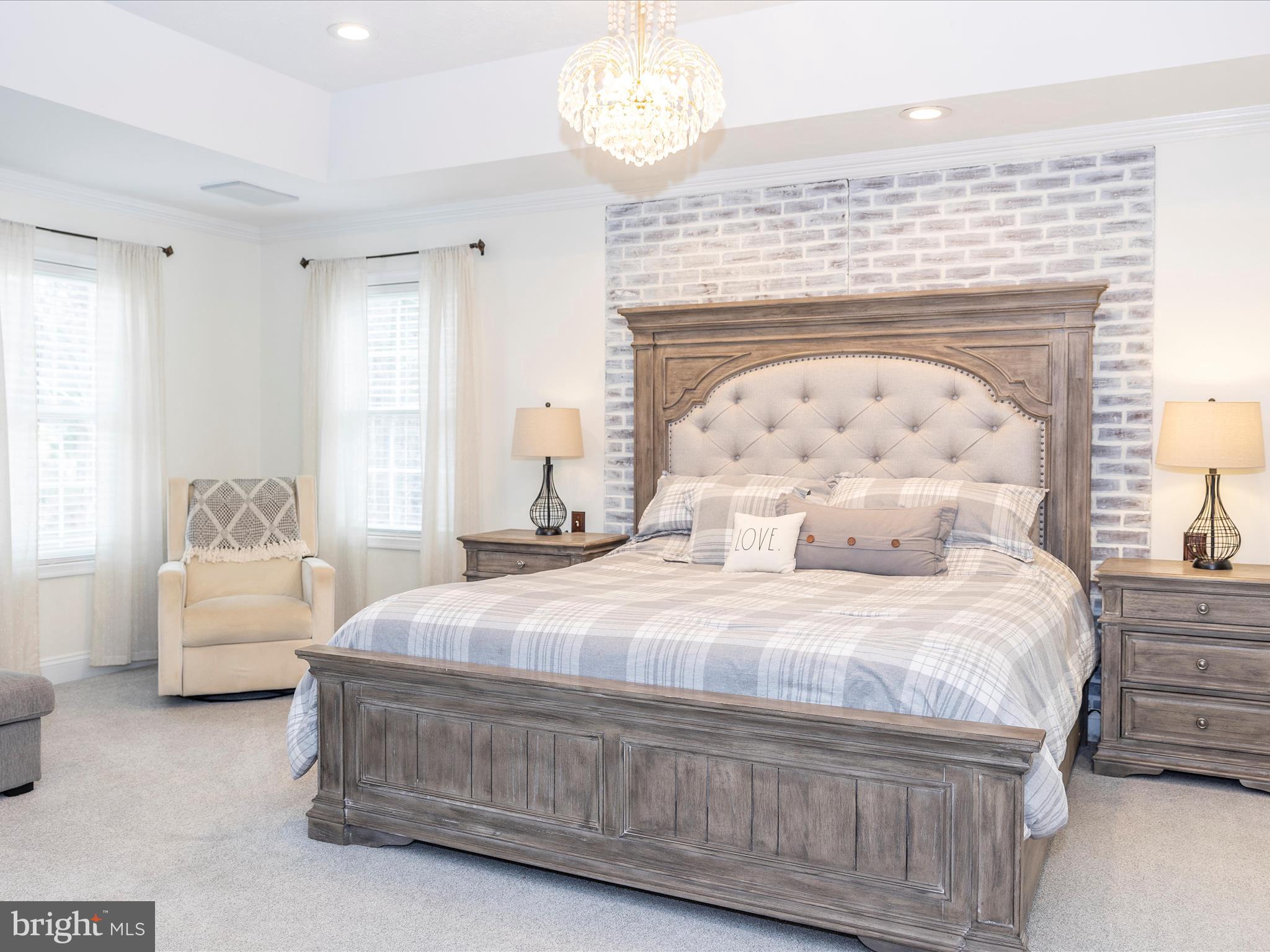 1345 Brehm Road Westminster, MD 21157 - Photo 38 of 131 a bedroom with a bed and a chandelier