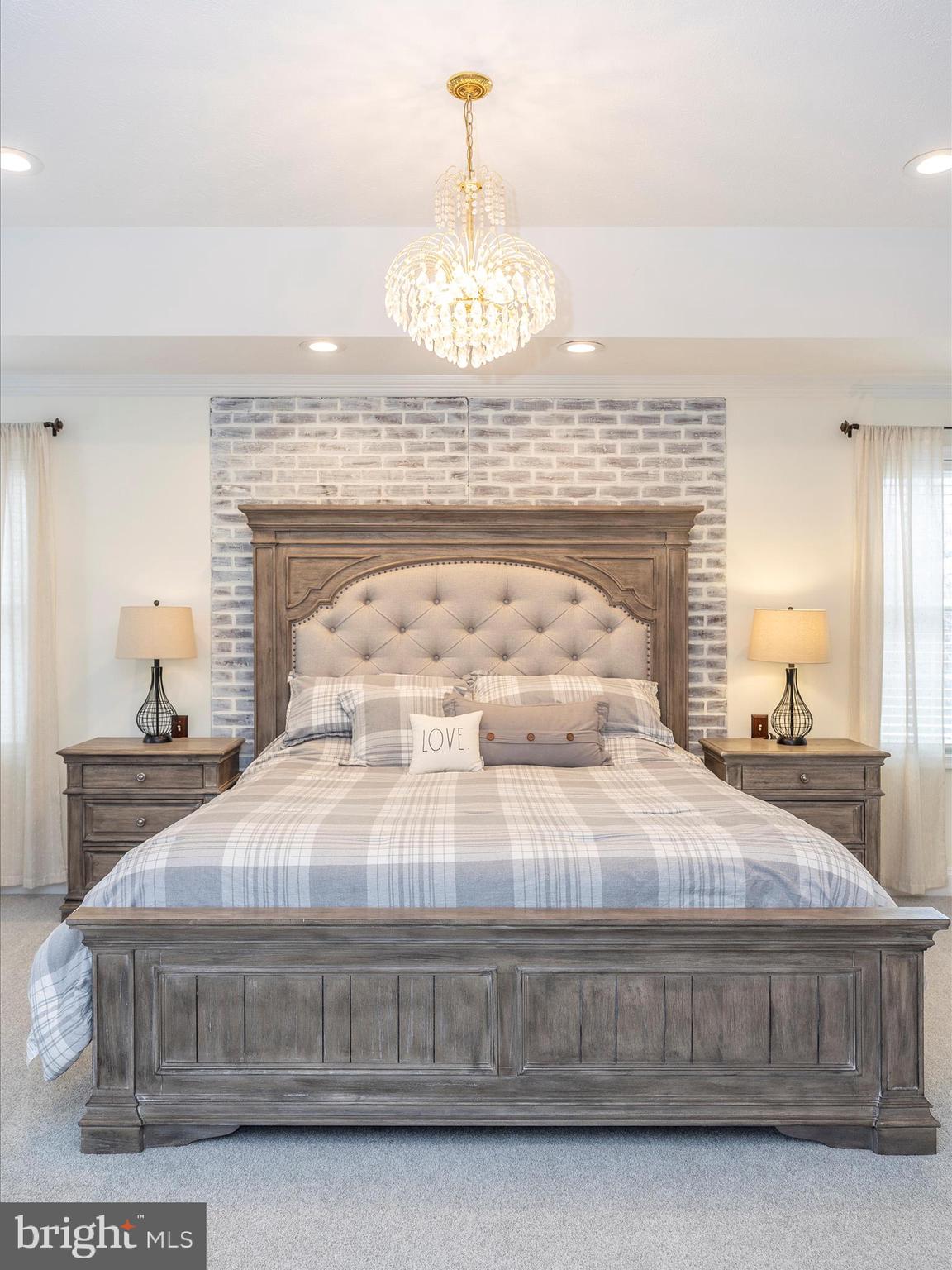 1345 Brehm Road Westminster, MD 21157 - Photo 39 of 131 a large white bed sitting in a bedroom next to a chandelier