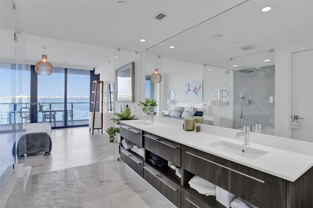 a spacious bathroom with a tub sink and glass door shower