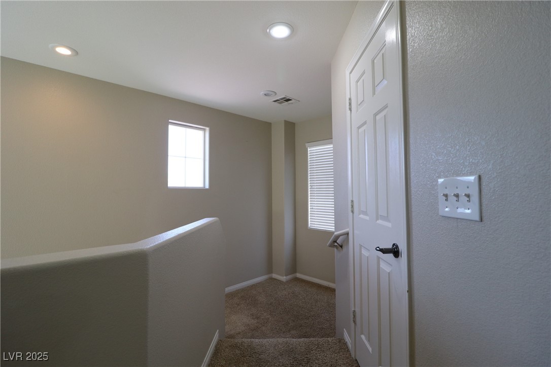 8708 Palomino Ranch Street Las Vegas, NV 89131 - Photo 14 of 19 Hall featuring light colored carpet, recessed lighting, and a textured wall
