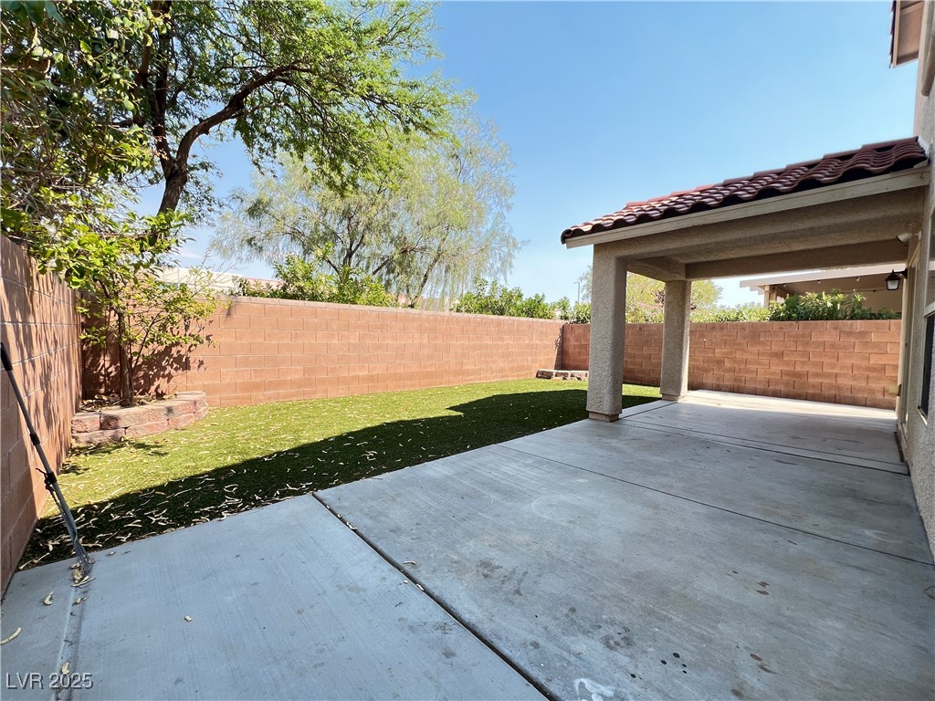 8708 Palomino Ranch Street Las Vegas, NV 89131 - Photo 15 of 19 Fenced backyard with a patio