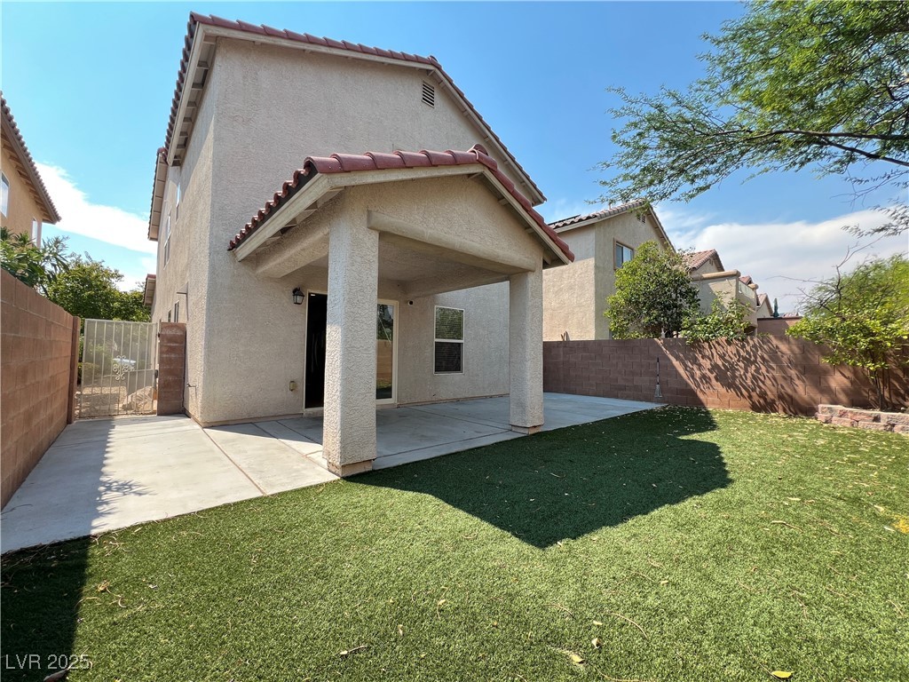 8708 Palomino Ranch Street Las Vegas, NV 89131 - Photo 17 of 19 Rear view of house with a patio, a tiled roof, stucco siding, and a fenced backyard