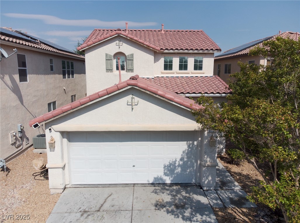 8708 Palomino Ranch Street Las Vegas, NV 89131 - Photo 19 of 19 Mediterranean / spanish-style house featuring stucco siding, driveway, and a tiled roof