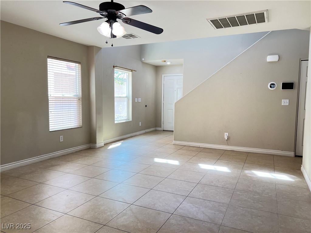 8708 Palomino Ranch Street Las Vegas, NV 89131 - Photo 6 of 19 Empty room with ceiling fan and light tile patterned floors