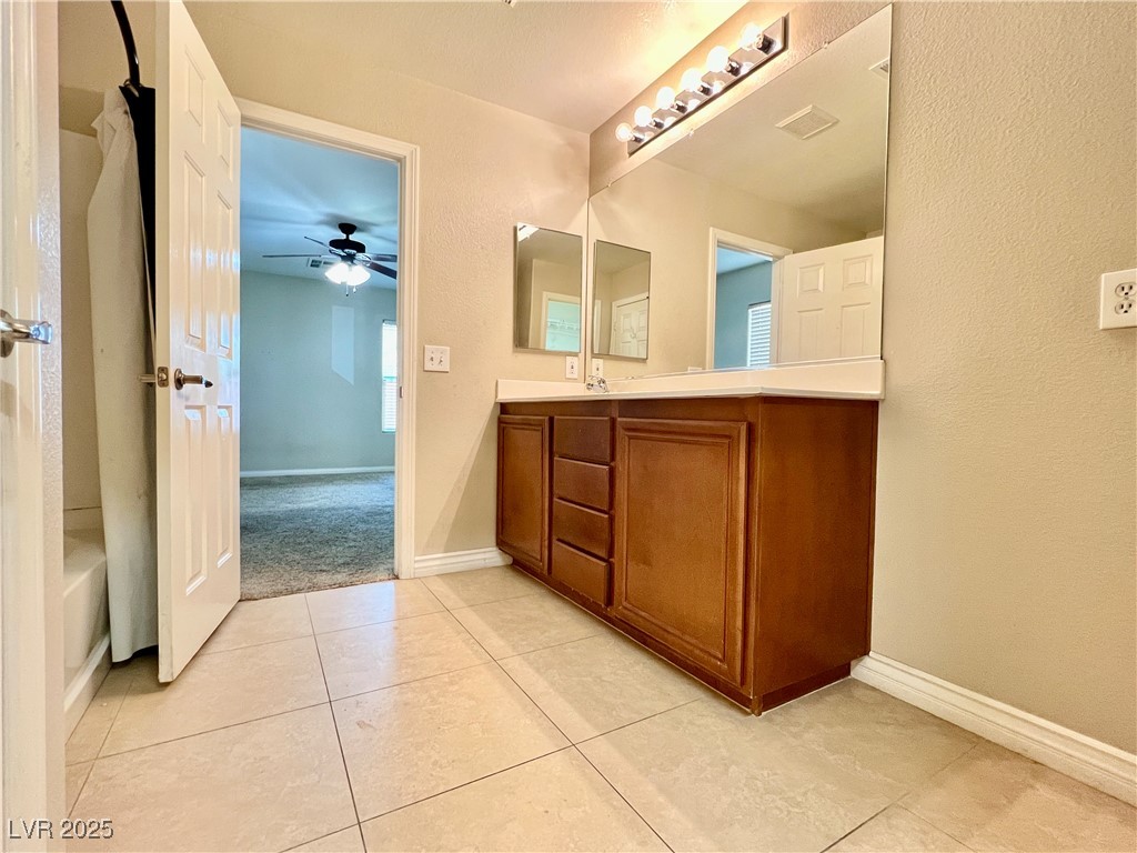 8708 Palomino Ranch Street Las Vegas, NV 89131 - Photo 9 of 19 Full bathroom with vanity, tile patterned flooring, and ceiling fan