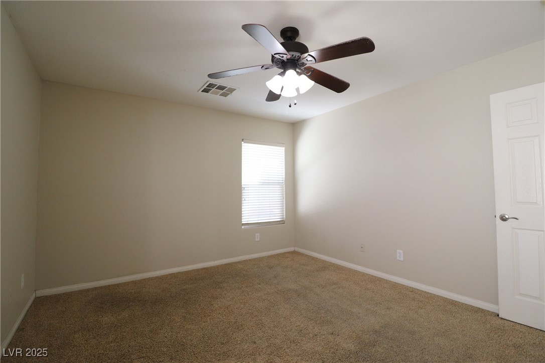 8708 Palomino Ranch Street Las Vegas, NV 89131 - Photo 10 of 19 Carpeted empty room with baseboards and ceiling fan