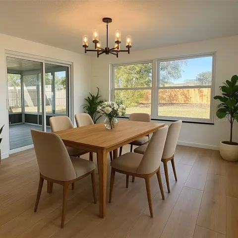 a view of a dining room with furniture wooden floor and chandelier