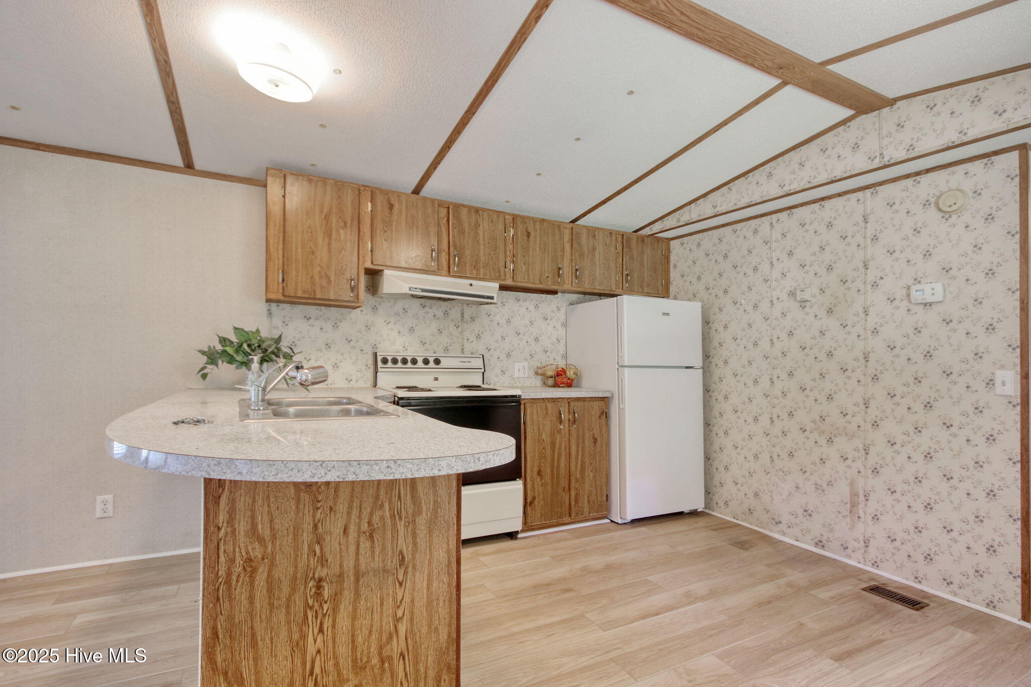 6952 Reed Trail Northwest Ocean Isle Beach, NC 28469 - Photo 5 of 25 Kitchen has a nice breakfast bar!