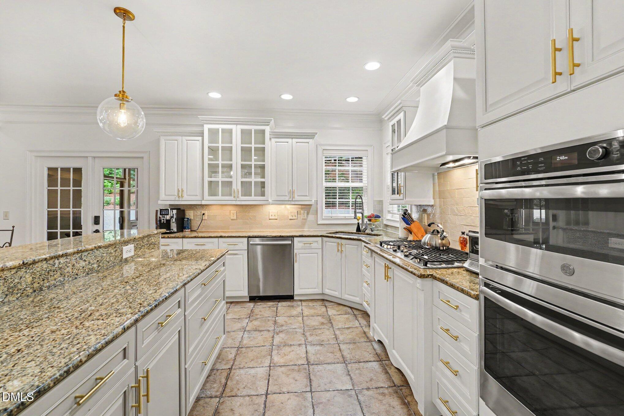 1729 Frenchwood Drive Raleigh, NC 27612 - Photo 8 of 46 a kitchen with a stove sink and cabinets