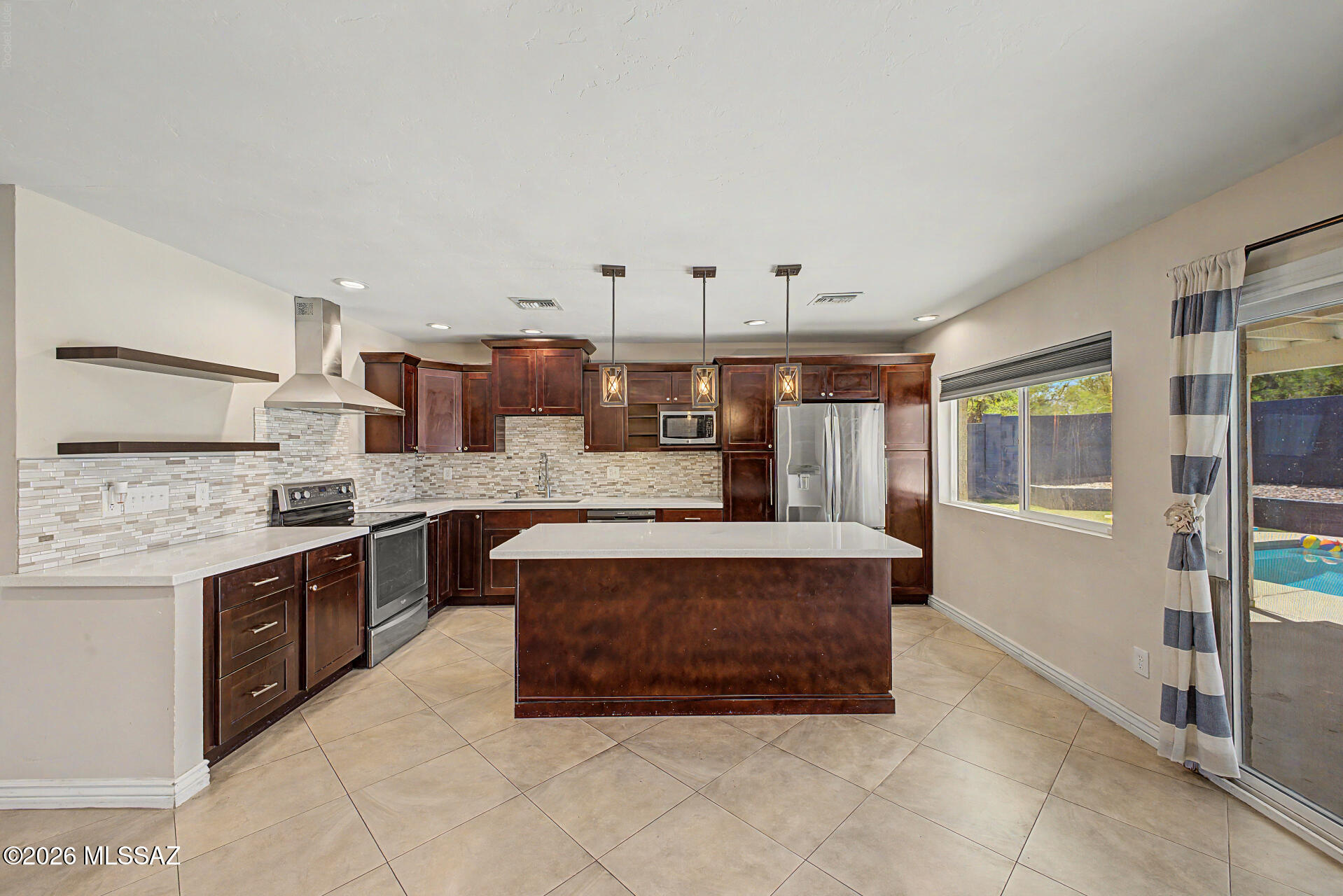 7550 East Rio Verde Drive Tucson, AZ 85715 - Photo 12 of 25 Natural light fills the kitchen, creating a welcoming space for cooking, gathering, and making memories.