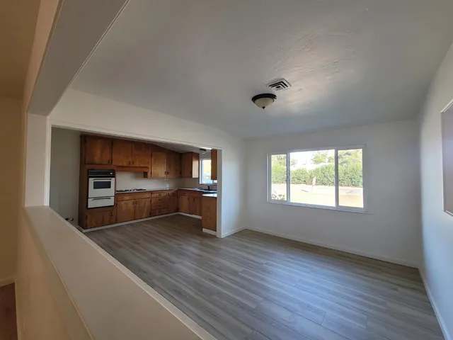an empty room with windows and cabinet