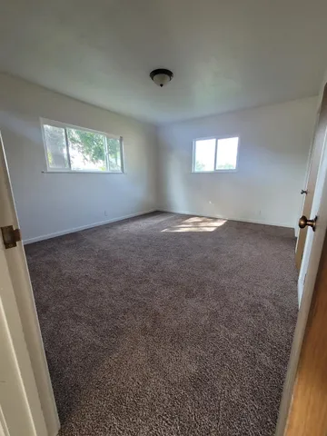 a view of an empty room and a window