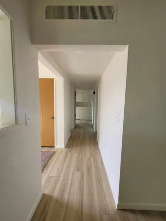 a view of a room with wooden floor