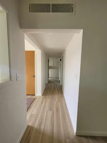 a view of a room with wooden floor
