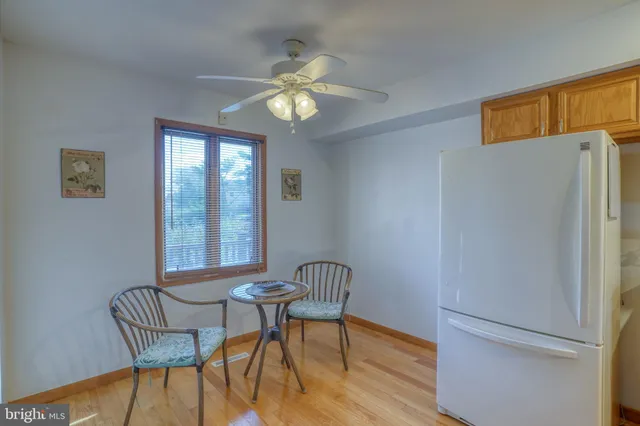 a view of dining room and livingroom with furniture window and wooden floor