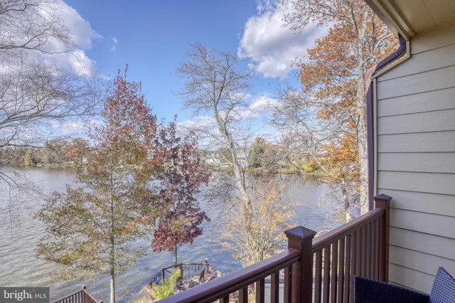 a view of a balcony with wooden fence and floor