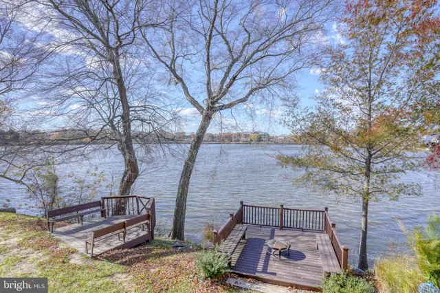 a view of a wooden balcony and trees