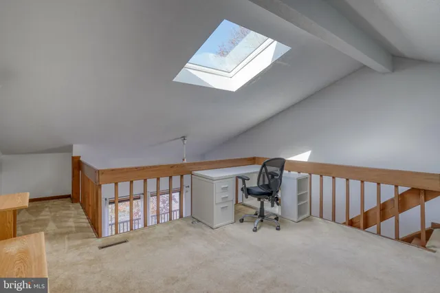 a bathroom with a granite countertop sink toilet and mirror