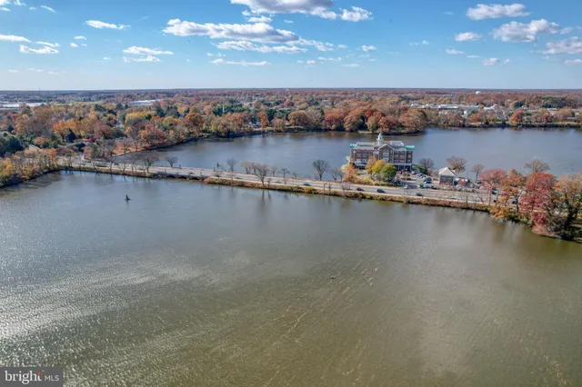 an aerial view of a residential building with outdoor space and lake view