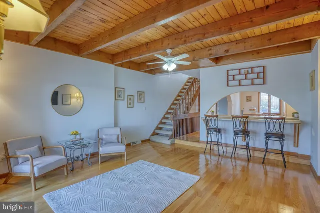a living room with furniture wooden floor and a table
