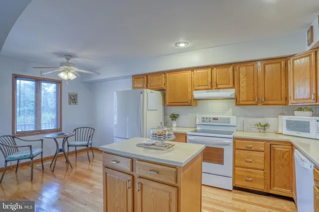 a kitchen with a sink a stove a refrigerator and cabinets