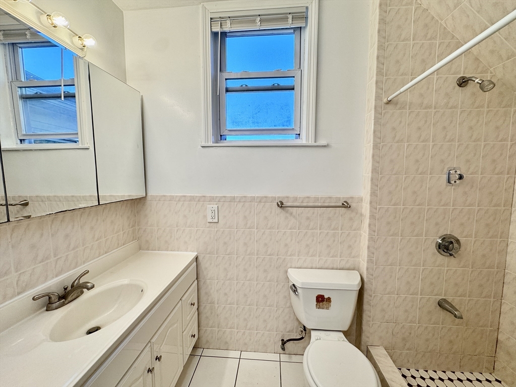 50 Mt Ararat Road, Unit 3 Quincy, MA 02169 - Photo 4 of 11 a bathroom with a sink a toilet and shower