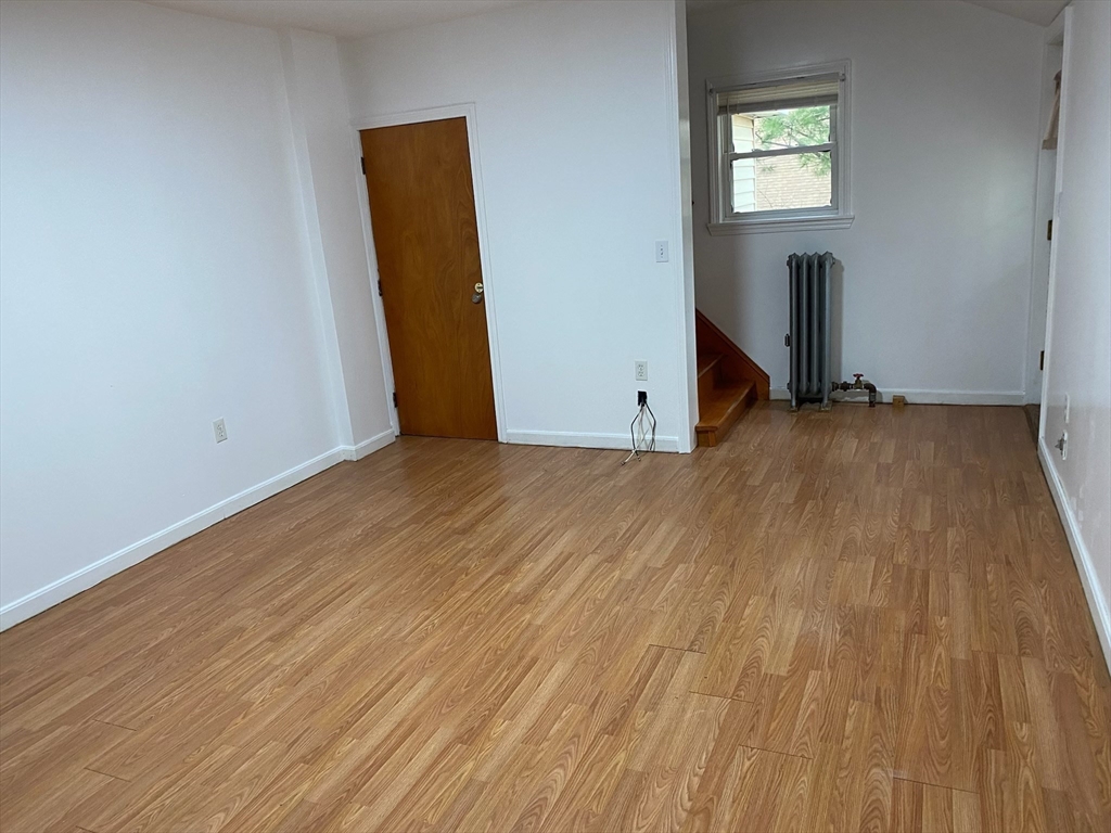 50 Mt Ararat Road, Unit 3 Quincy, MA 02169 - Photo 7 of 11 an empty room with wooden floor and windows