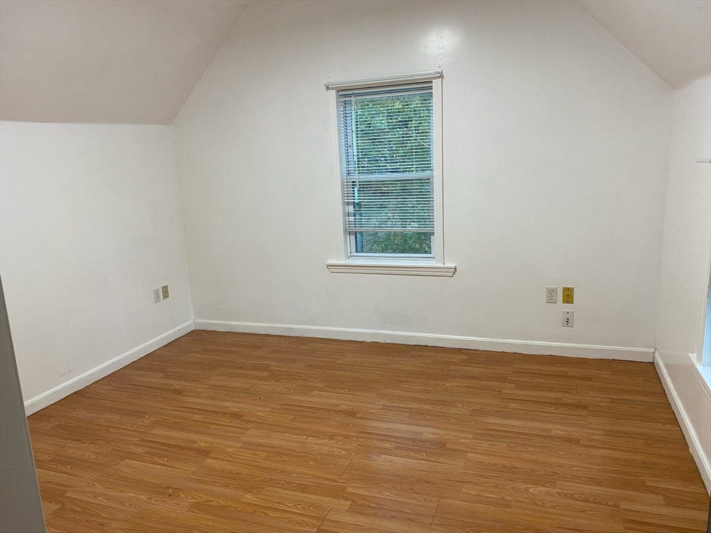 50 Mt Ararat Road, Unit 3 Quincy, MA 02169 - Photo 9 of 11 an empty room with wooden floor and windows