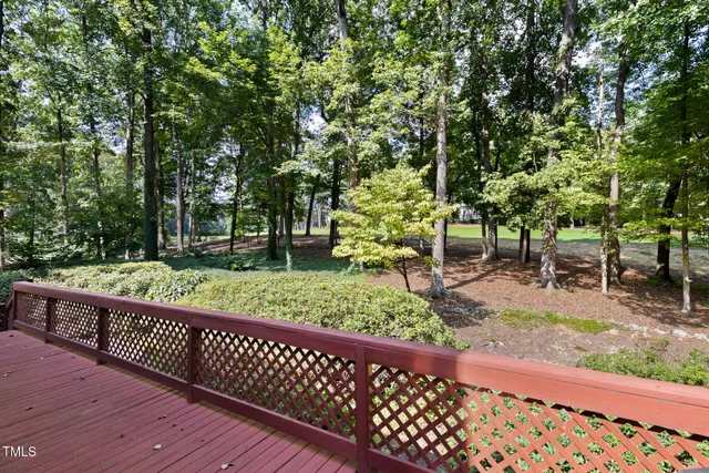 a view of a wooden deck next to a yard