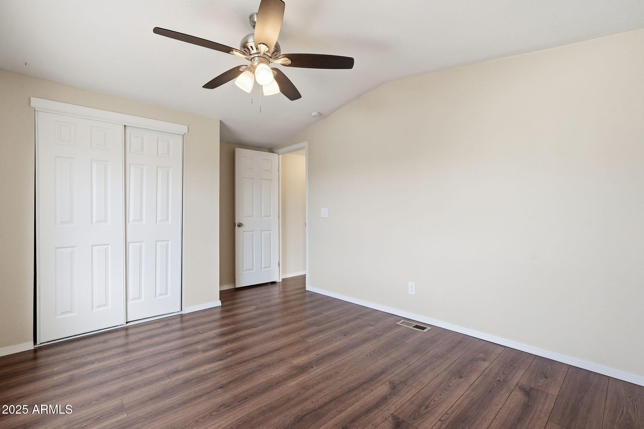 320 East McKellips Road, Unit 166 Mesa, AZ 85201 - Photo 13 of 24 an empty room with wooden floor ceiling fan and windows
