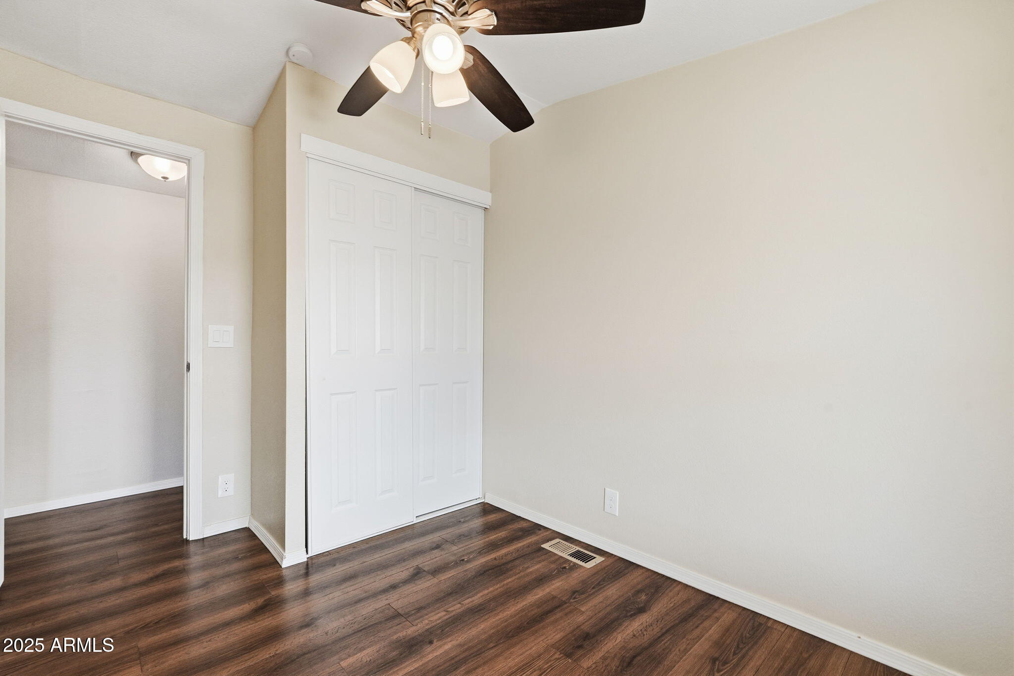 320 East McKellips Road, Unit 166 Mesa, AZ 85201 - Photo 15 of 24 a view of an empty room with wooden floor