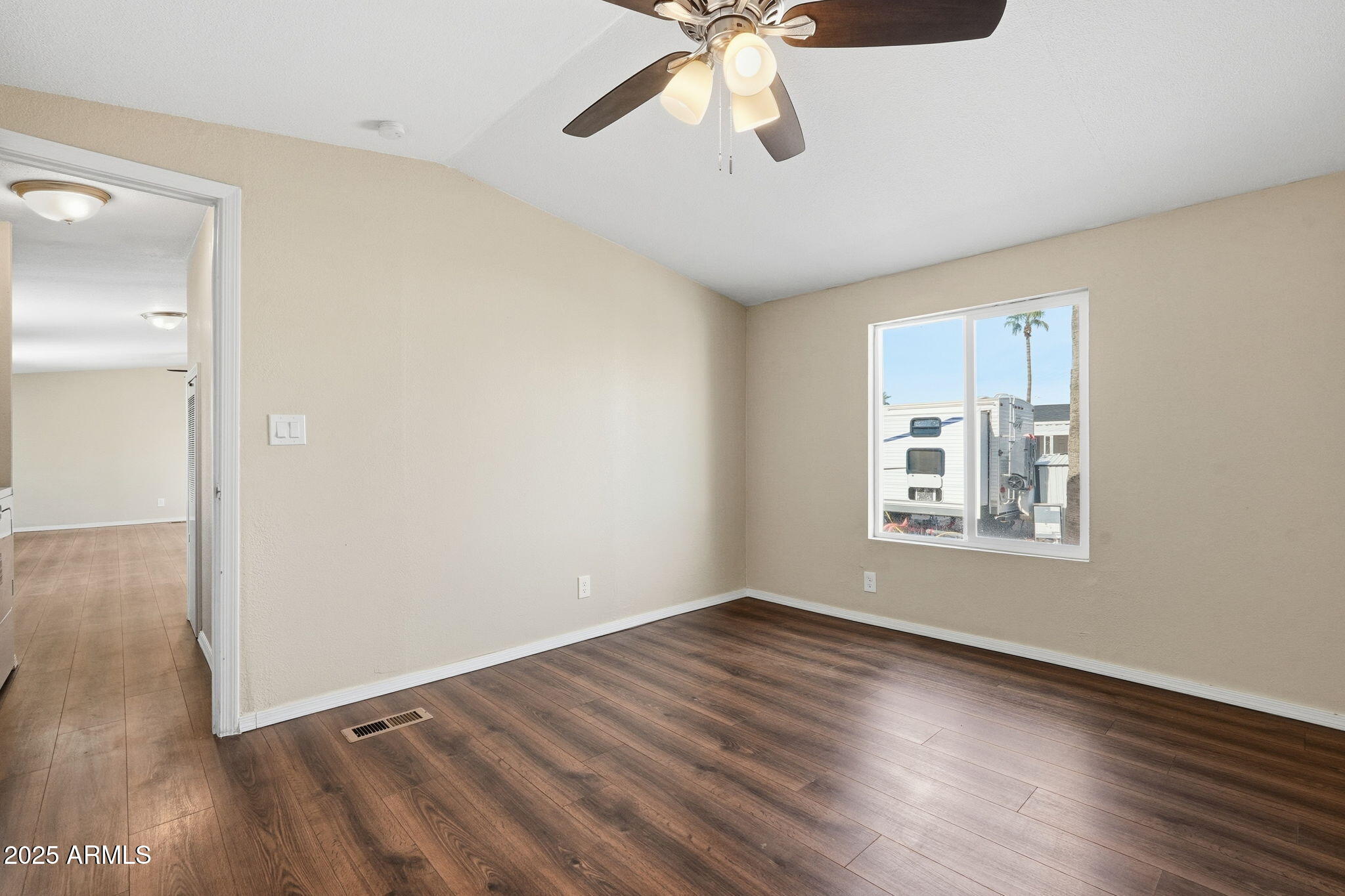 320 East McKellips Road, Unit 166 Mesa, AZ 85201 - Photo 16 of 24 a view of an empty room with wooden floor and a window
